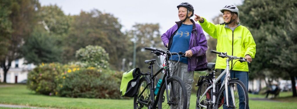 two people with bikes in park